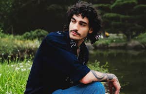 Man sitting contemplatively by a calm lake, illustrating the need for a personal space to process tears and emotions over the years