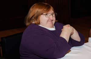 Disabled author smiling in a self-portrait, illustrating how living with a disability can make someone a more compassionate partner.