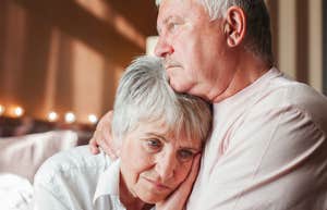 lonely older parents holding each other