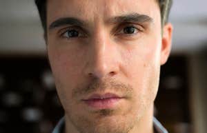 Cold intense person with an unsettling expression showing the subtle warning signs when someone crosses the line from narcissist to sociopath.