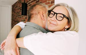 Couple sharing a warm embrace after reconciling, illustrating the gentle phrases and emotional connection of couples who resist big fights.