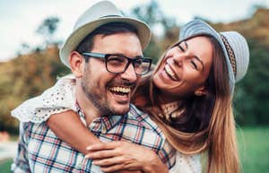 happy couple who are meant to be hugging each other and laughing