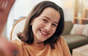 emotionally intelligent woman taking selfie and smiling