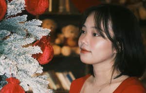 Woman puts up holiday decor.