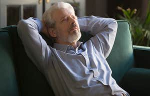 older man peacefully napping on his couch alone
