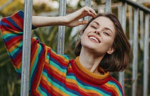 People Who Think Smarter And Faster Than Everyone Else Usually Have These Hobbies That Bore Average Minds woman who thinks smarter and faster smiling on railing