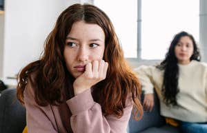 young woman sitting away from friend who isn't good for her