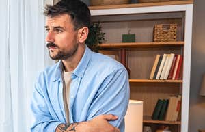 man standing alone in his home while his life collapses