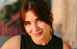 Calming Steps To Take This Year If You Want Less Stress And More Peace Woman looking at the camera outdoors.