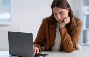 young woman working on laptop at table
