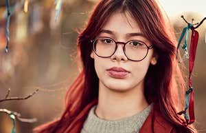 Young person with high IQ and low self-esteem outdoors 