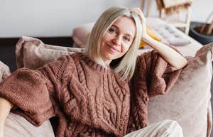 smiling woman relaxing on couch at home