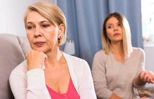 sad older woman turned away from her adult daughter