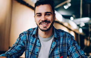 Lone wolf man smiling in a restaurant alone 