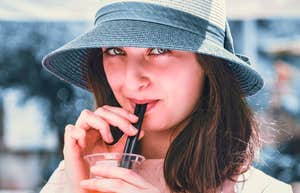 People Who Can't Stand Using Paper Straws And Wooden To-Go Spoons Usually Have Distinct Traits woman who hates paper straws using plastic straw in drink