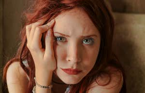 Woman with her hand on her face, appearing low and withdrawn, illustrating quiet slumps and strategies to climb back out