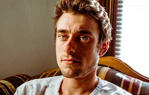 Self-absorbed man looks smugly into camera