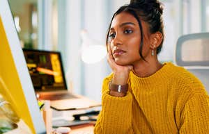 Signs Your Co-worker Has Zero Life Outside Of Work And It's Annoying Everyone Around Them woman at work with zero life outside her job looking sad