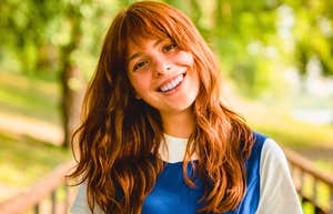 happy unbothered woman smiling outside