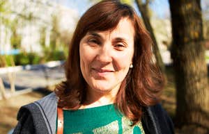 A portrait of a beautiful smiling senior woman with brown hair, illustrating 'positive affect' and the emotional maturity of the fifties and sixties.