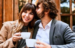 Successful man smiling at a woman in a cafe 