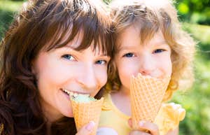 Rare Things Kids Never Forget About Parents Who Made Them Feel Truly Loved A happy mother and child eating ice cream, illustrating the 'joint attention' and shared joy that build a secure attachment bond.