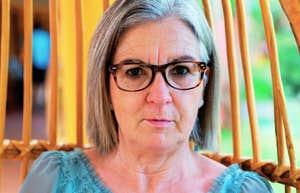 We’re Witnessing A Massive Surge In Parental Estrangement, And So Many Boomer Parents Still Don’t Get Why A portrait of a senior woman reflecting in a rattan chair, representing the 'estrangement surge' and the disconnect between traditional and modern parenting values.