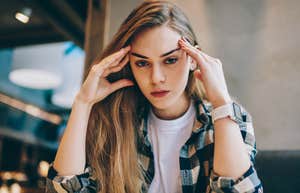 Serious intelligent woman looking stern to avoid emotions
