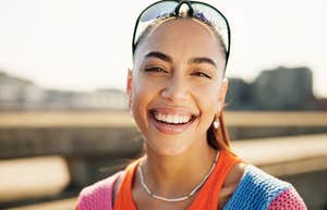portrait of smiling woman standing outside