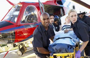 paramedics getting patient off a medevac flight on hospital's helipad