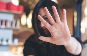 Woman saying no without being rude putting her hand up 