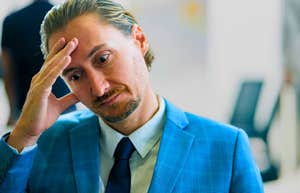 man with a low iq feeling frustrated and stressed at work