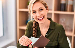 financially responsible woman saving money holding her wallet