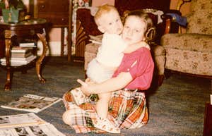 1960s little girl babysitting her younger brother as a chore