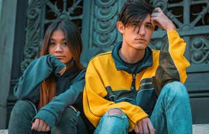brother and sister siblings sitting next to each other looking serious