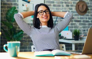 Things Boomer And Gen X Bosses Get Wrong About The Way Gen Z Works gen z woman working in an office smiling