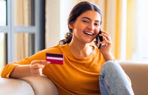Comfort Items Gen Z And Millennials Spend Hundreds On Each Month That Older Generations Never Needed young Gen Z woman making a comfort purchase on her phone