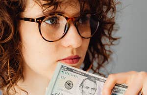 young woman holding money to invest