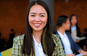 young gen Z worker smiling in the office