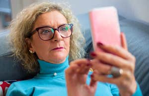 boomer woman looking at her phone seeming annoyed