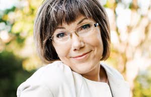 Her wry, knowing smile over the glasses hints at judgments she's not hiding as well as she thinks.