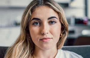 Woman who is losing her ability to forgive with a wry smile 