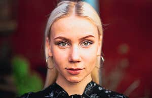 Phrases People Say When They Can't Pretend To Be Interested In Small Talk serious woman who can't pretend to enjoy small talk