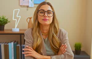 Workplace Traditions Older Generations Thought Were Important That Gen Z Doesn't Care About unimpressed gen Z professional worker in the office