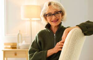 Things People Who Grew Up In A Home Where Money Was Tight Keep For A Long Time older woman smiling in her living room chair