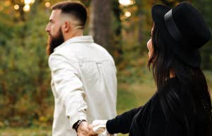 man and woman walking holding hands