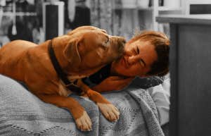 woman on bed with dog