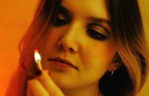 Unhealthy Signs The Person You Love Has A Martyr Complex woman holding flame