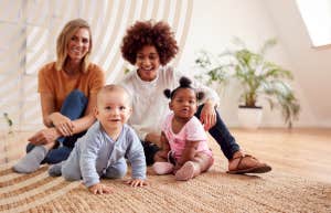 moms talking, watching their babies play