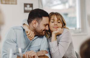Couples With These 5 Boundaries Never Cheat Affectionate woman embracing her husband while sitting at dining table.